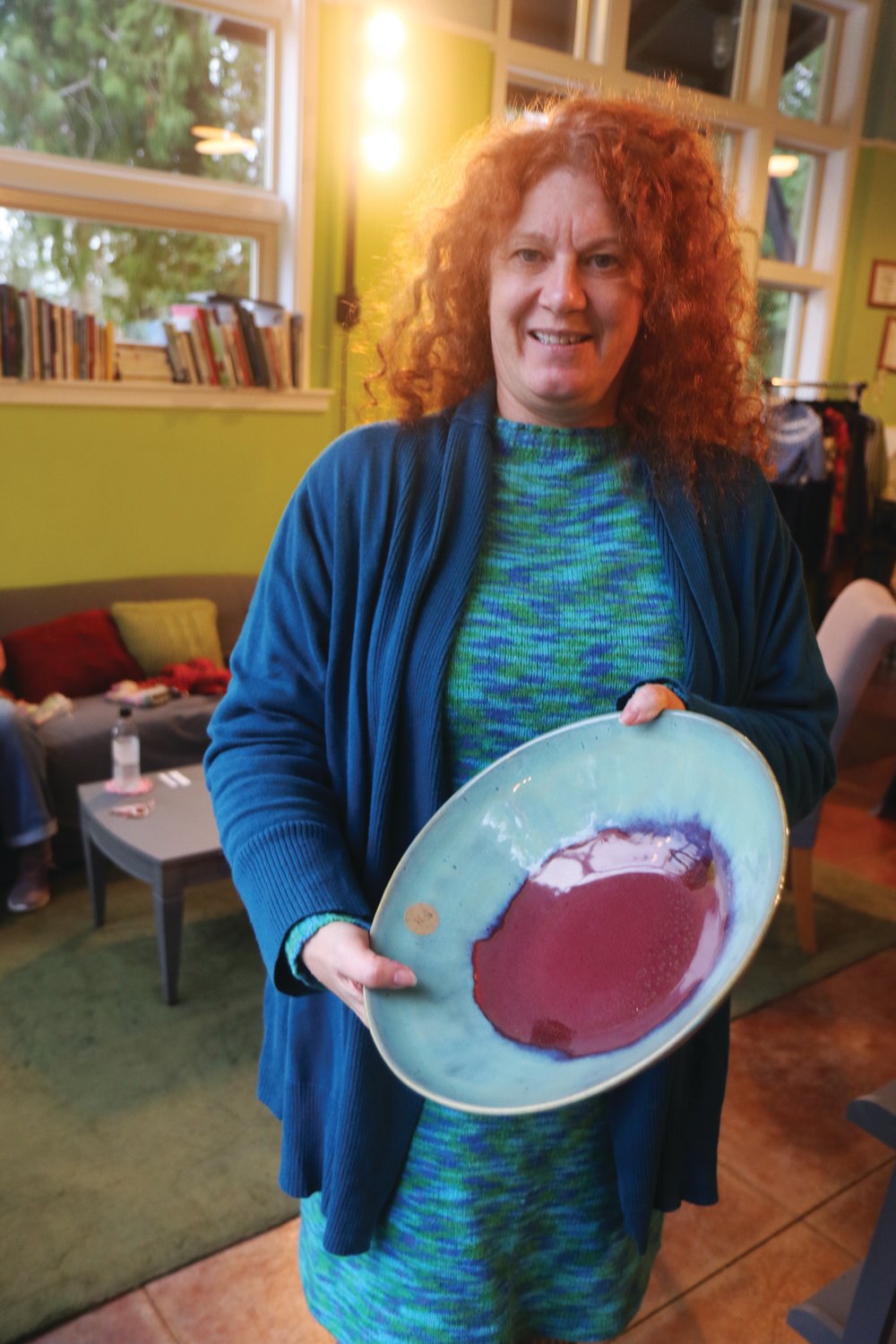 Lise Solvang, one half of Qulicene’s Fiber and Clay store, holds a bowl crafted by partner, Scot Olson.
